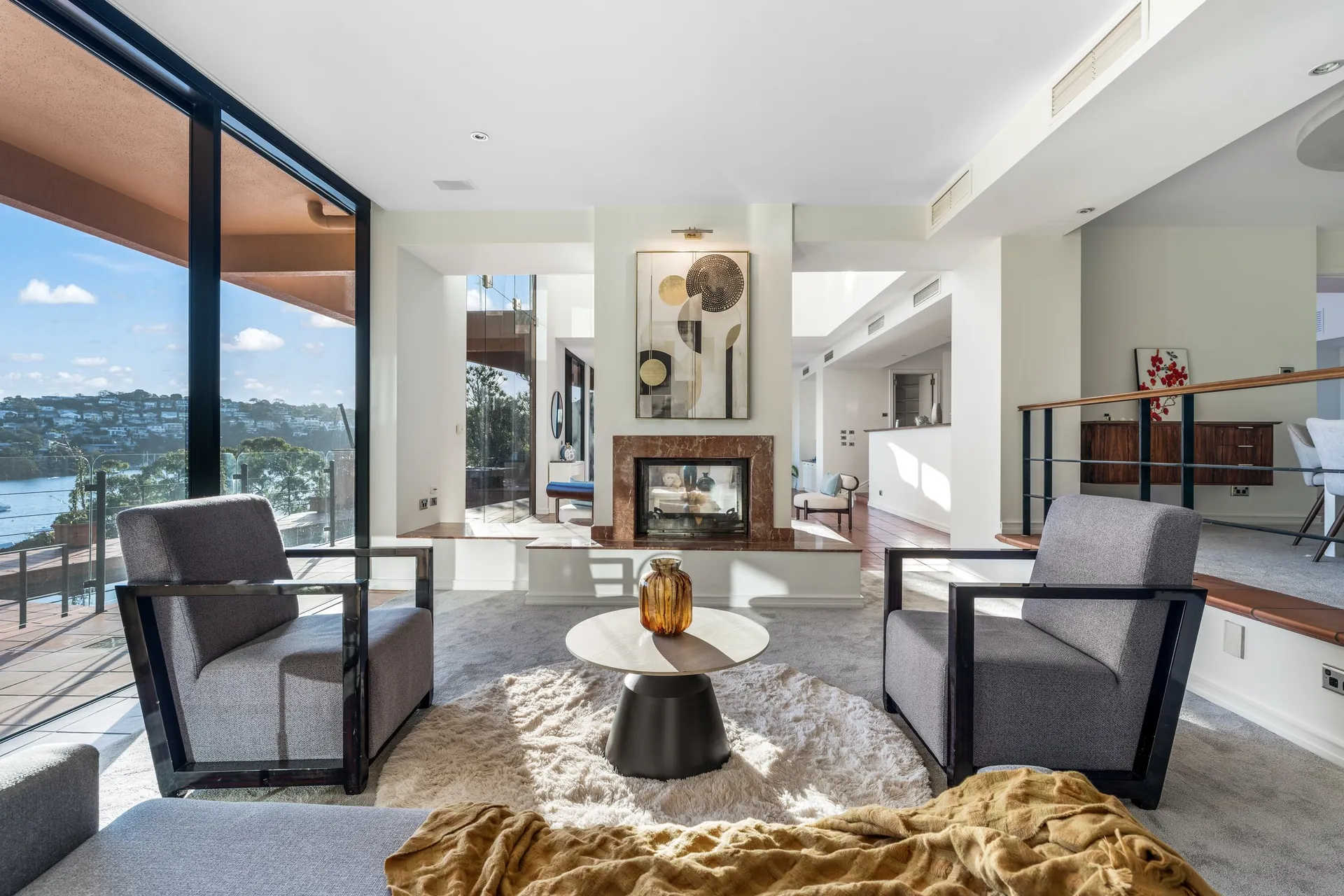 Mosman sitting room with fireplace and water view